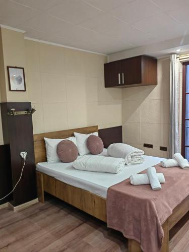 a bedroom with a large bed with white pillows at Hostel By the Hill in Veliko Tŭrnovo