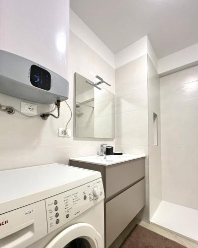 a white laundry room with a washer and dryer at Bergeggi Sea View Apartment - Torre del Mare in Bergeggi