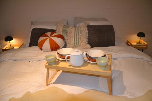 a table with plates and cups on a bed at Nature and tranquility in Soest with Forest, Dunes and City in Soest