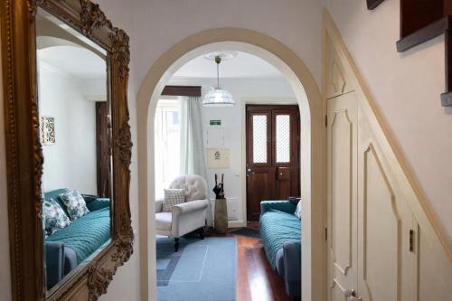 an archway leading into a living room with a mirror at Violeta House in Funchal