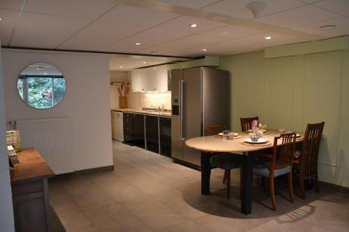 a kitchen and dining room with a table and chairs at Nature and tranquility in Soest with Forest, Dunes and City in Soest