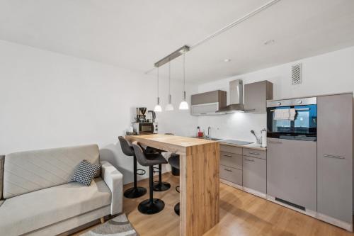 a kitchen with a couch and a table in a room at Ramoni Apartments - NaturTraum Kniebis in Freudenstadt