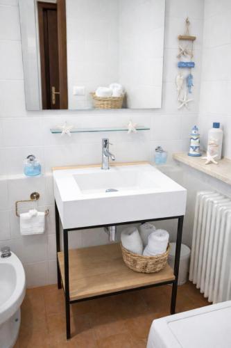 a bathroom with a sink and a toilet at Blue Bay Apartment in Cala Bitta