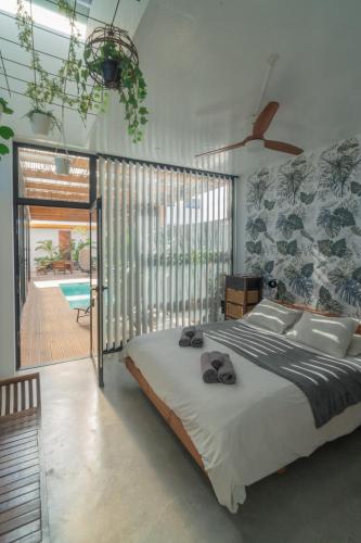 a bedroom with a large bed with towels on it at BaliHouse by Aura Collection in La Oliva