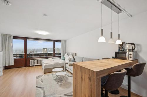 a kitchen and living room with a table and a couch at Ramoni Apartments - NaturTraum Kniebis in Freudenstadt
