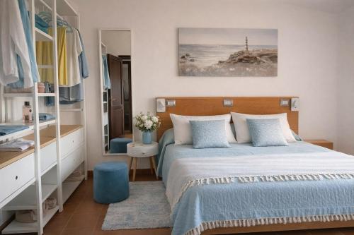 a small bedroom with a bed and a mirror at Blue Bay Apartment in Cala Bitta