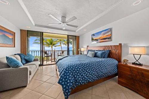 a bedroom with a bed and a couch at Aloha Oceanfront Retreat 327 in Lahaina