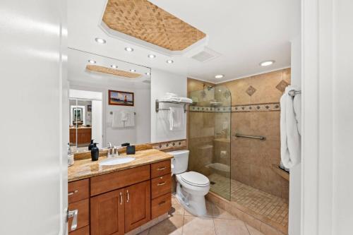 a bathroom with a shower and a toilet and a sink at Aloha Oceanfront Retreat 327 in Lahaina
