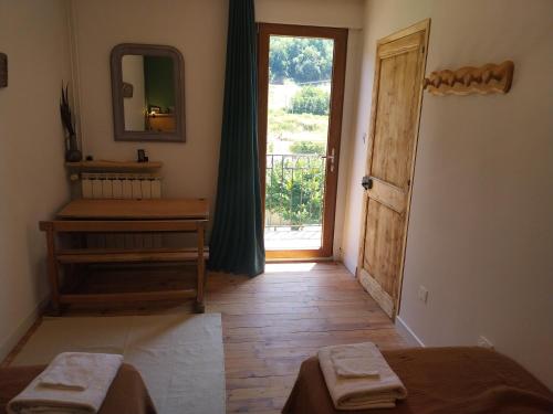 a room with a door leading to a room with a window at La chambre du Villard in Saint-Béron