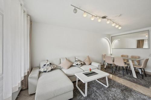 a living room with a couch and a table at Ramoni Apartments - Naturglück in Enzklösterle