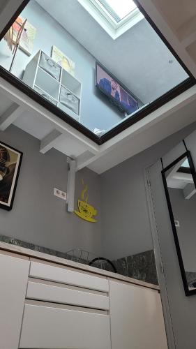 a kitchen with a skylight in the ceiling at Appartement Duplex 40 M² in Fontenay-Trésigny