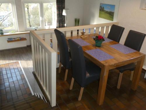 a dining room table with black chairs and a wooden table at Holiday Home Stausee by Interhome in Biersdorf am See