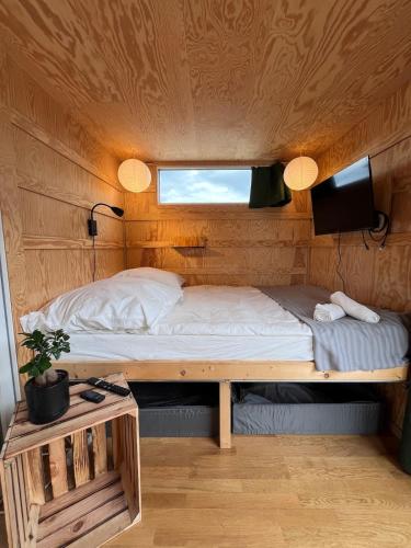 a bed in a small room with a window at Berlin River Retreat in Berlin