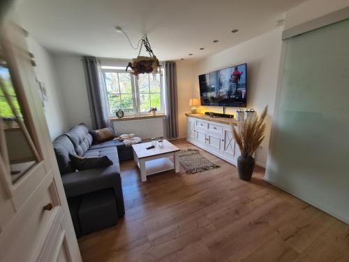 a living room with a couch and a table at Apartment Waldstein Terrassen by Interhome in Weißenstadt