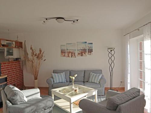 a living room with two couches and a table at Apartment Tohus - Wigbold by Interhome in Middelhagen
