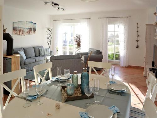 a living room with a table with wine glasses on it at Apartment Tohus - Wigbold by Interhome in Middelhagen