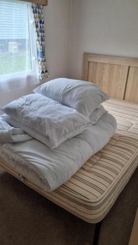 a bed with two pillows on top of it at 87 Mountain View, Hafan Y Mor in Afon Wen Junction