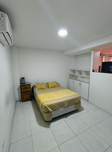 a bedroom with a bed in a white room at Complejo belgrano in General Roca