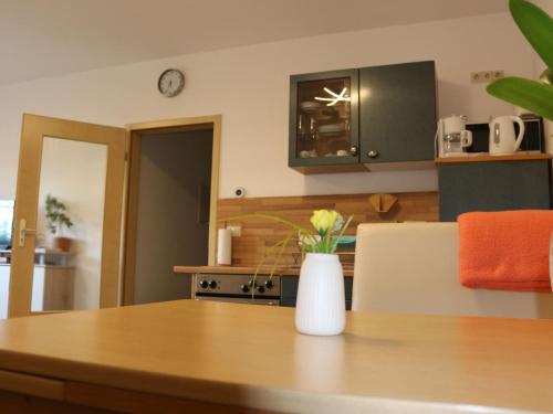a kitchen with a table with a vase of flowers on it at Apartment Paula by Interhome in Neundorf