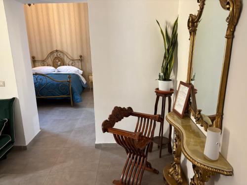 a hallway with a bedroom with a bed and a mirror at Borgo Scorciarini B&B in Piedimonte dʼAlife