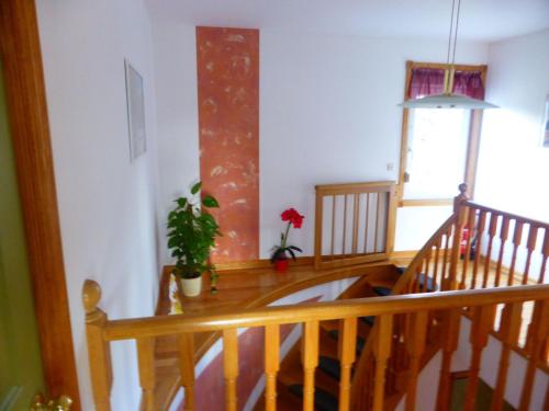 a room with a wooden staircase with a potted plant at Holiday Home Windrad by Interhome in Auerbach