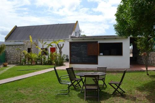 a table and chairs in front of a building at The Plot West Coast Style Glamping & Accommodation in Jacobs Bay