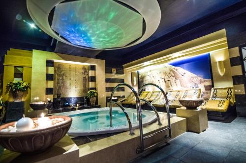 a large bathroom with a tub and a sink at Hotel Falko in Rumia