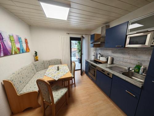 a small kitchen with a table and a couch at Apartment Siegmund by Interhome in Waltershausen