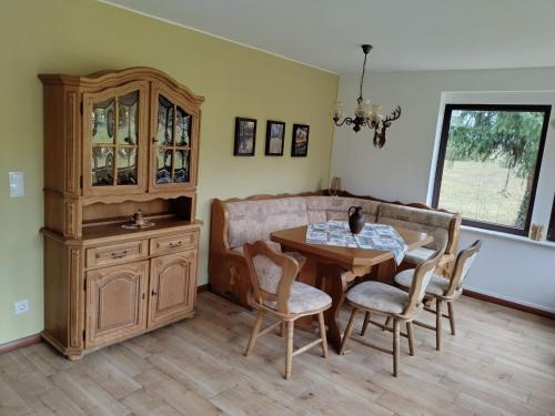 a dining room with a table and a china cabinet at Holiday Home Itzinger by Interhome in Ziesar