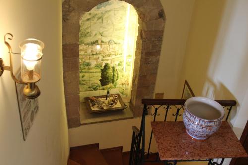 a hallway with a table and a painting on the wall at Hotel Pallotta in Assisi