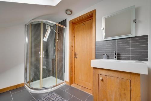 a bathroom with a shower and a sink at 4 Bed in High Peak oc-dcchb in Chinley