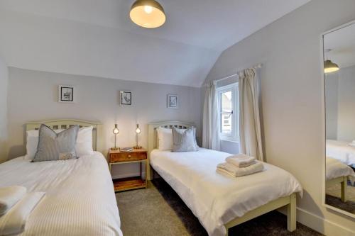 a bedroom with two beds and a window at 2 Bed in Appledore oc-whimbc in Appledore