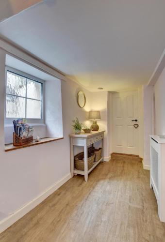an empty living room with a table and a window at 2 Bed in Appledore oc-whimbc in Appledore
