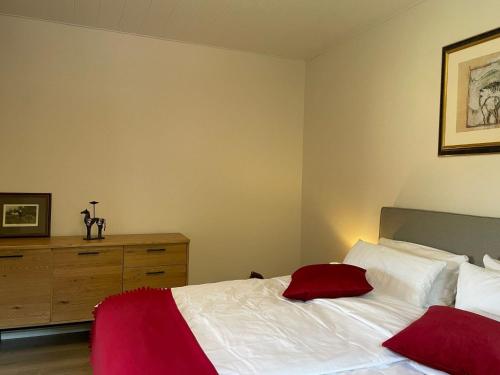 a bedroom with a white bed and a dresser at Apartment Annika by Interhome in Hückeswagen
