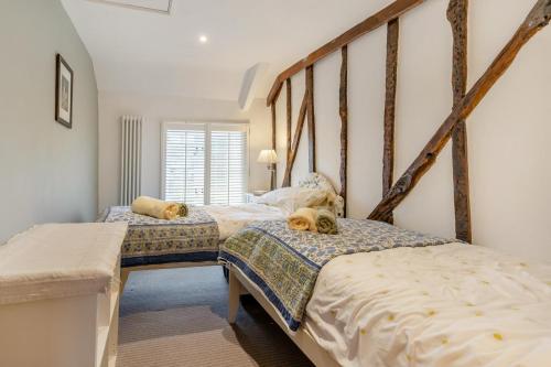 two twin beds in a room with white walls at 3 Bed in Trellech oc-j34206 in Trelleck