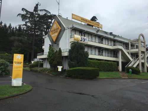 a building with a sign in front of it at Premiere Classe St Etienne Nord Villars in Villars