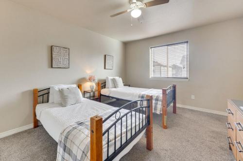 a bedroom with two beds and a ceiling fan at Private Yard • BBQ • Patio • Sleeps 8 • 4BR in Colorado Springs