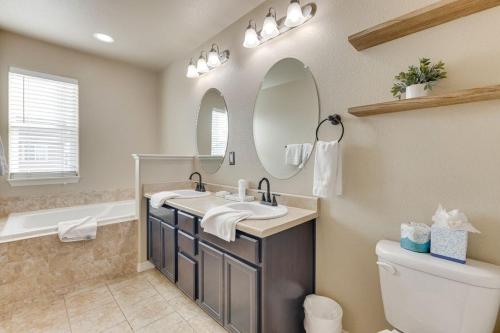 a bathroom with a sink and a mirror at Private Yard • BBQ • Patio • Sleeps 8 • 4BR in Colorado Springs
