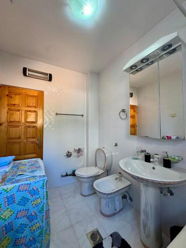 a bathroom with a toilet and a sink at Apartment Magdalena in Dobrota