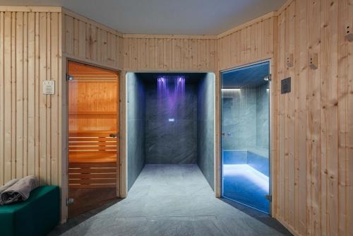 a bathroom with a shower and a tub at ecHo Apartments & SPA in Bressanone