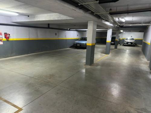 a parking garage with two cars parked in it at Altos de Centro Chivilcoy 6 in Chivilcoy