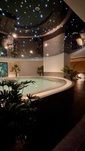 a swimming pool in a building with stars on the ceiling at Your Holidays Bel Mare Aqua F109 in Międzyzdroje