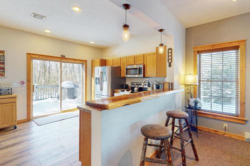 a kitchen with a counter and two stools at Northridge 199 in Tannersville