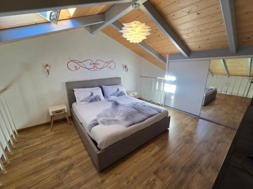a bedroom with a large bed in a attic at marinella house 2 in Sarzana