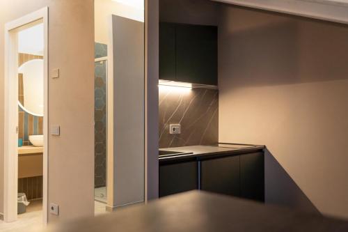 a kitchen with black cabinets and a counter top at Villa Eliseo in Modena