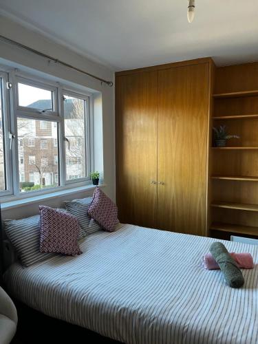a bedroom with a large bed with pillows on it at Urban Snooze in Herne Hill