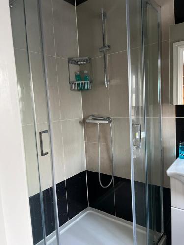 a shower with a glass door in a bathroom at Urban Snooze in Herne Hill