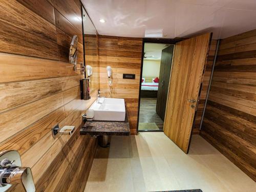 a bathroom with a sink and a mirror at Arcadian Hotel in Gangtok