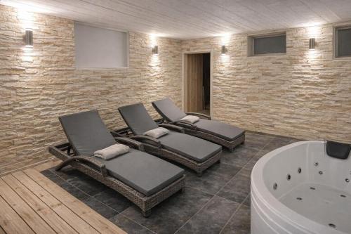 a bathroom with three chairs and a bath tub at Little Sven#s House in Mellansel