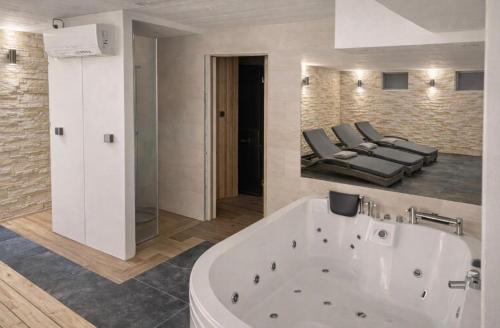 a large bathroom with a tub and a bed at Little Sven#s House in Mellansel